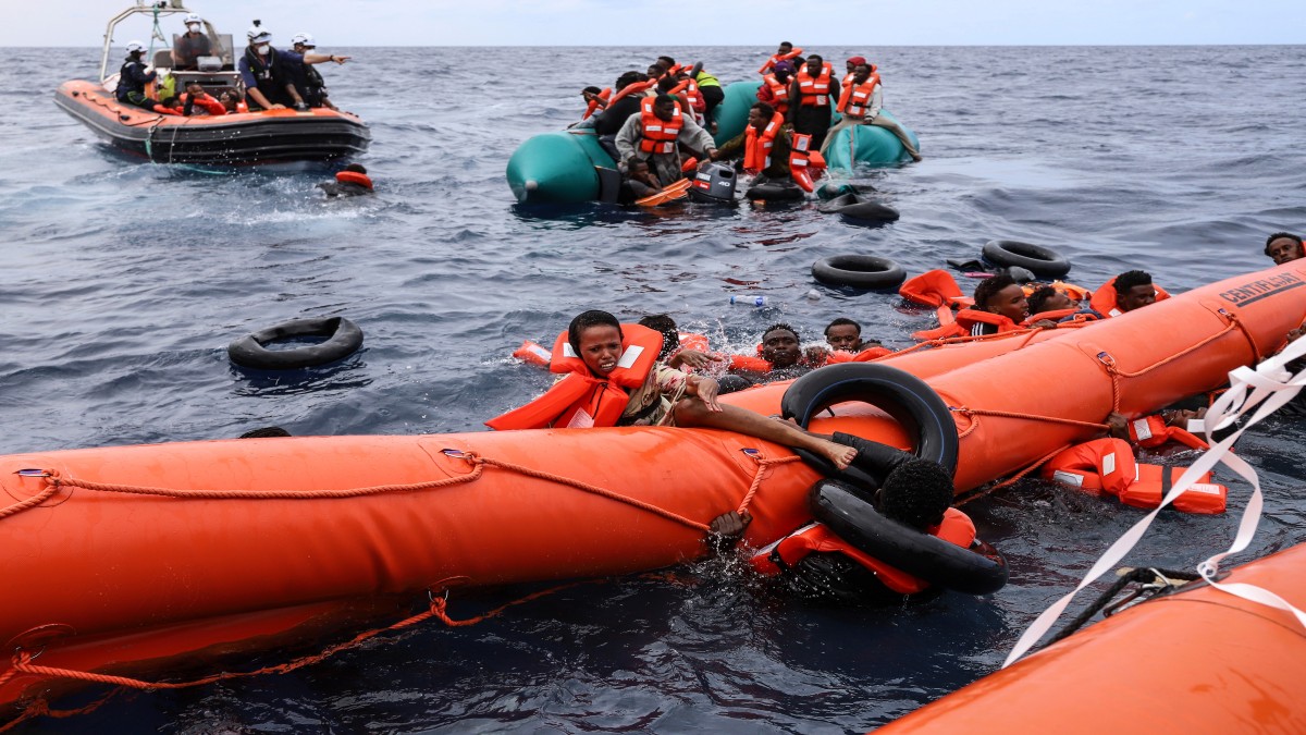 Migrants aboard a rubber boat end up in the water while others cling on to a centifloat before being rescued by a team of the Sea Watch-3, around 35 miles away from Libya. AP File Migrants aboard a rubber boat end up in the water while others cling on to a centifloat before being rescued by a team of the Sea Watch-3, around 35 miles away from Libya. AP File
