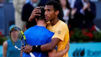 Felix Auger-Aliassime, of Canada, embraces Jiri Lehecka, of the Czech Republic, after a semi-final match at the Mutua Madrid Open tennis tournament. AP
