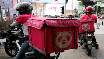 Foodpanda riders get ready for deliveries outside a restaurant. Reuters File