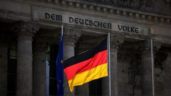 The German national flag flies in front of the Reichstag building, the seat of the lower house of the parliament Bundestag, in Berlin, Germany. Source: REUTERS/FILE.