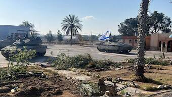 This photo provided by the Israel Defense Forces shows a tank with an Israel flag on it entering the Gazan side of the Rafah border crossing on May 7, 2024. Israel Defense Forces via AP