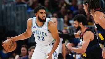 Minnesota Timberwolves center Karl-Anthony Towns, left, looks to drive to the basket as Denver Nuggets guard Jamal Murray, center, and forward Aaron Gordon defend. AP