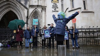 Environmental campaigners celebrate outside the High Court in London, Britain on 3 May, 2024. Reuters