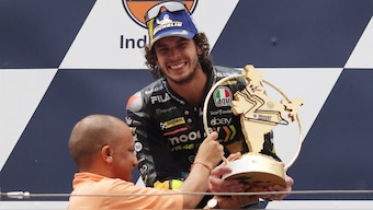 Italy's Marco Bezzecchi receives the winner's trophy from Uttar Pradesh Chief Minister Yogi Adityanath following his victory in the inaugural MotoGP Bharat. Reuters