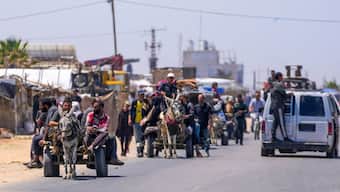 Displaced Palestinians arrive in central Gaza after fleeing from the southern Gaza city of Rafah in Deir al Balah, Gaza Strip, on 9 May, 2024. AP