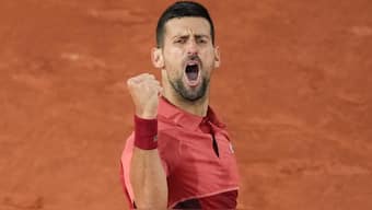 Novak Djokovic clenches his fist after winning a point against Pierre-Hugues Herbert during his first round match at the French Open. AP
