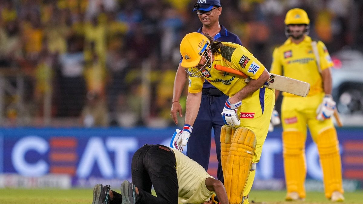 The fan who invaded the pitch during GT vs CSK IPL 2024 clash in Ahmedabad touches MS Dhoni's feet. Image: PTI The fan who invaded the pitch during GT vs CSK IPL 2024 clash in Ahmedabad touches MS Dhoni's feet. Image: PTI