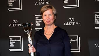 Jenny Erpenbeck, author of 'Kairos', holds the trophy after winning the International Booker Prize, in London, Tuesday, May 21, 2024.- AP