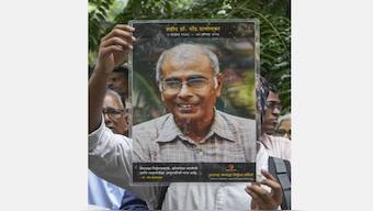 Maharashtra Andhashraddha Nirmulan Samiti member shows a portrait of Narendra Dabholkar during a ‘Nirbhay’ rally on his 10th death anniversary, in Mumbai on 19 August, 2023. He was fatally shot while on his morning walk near the VR Shinde bridge in Pune on 20 August 2013. File image/PTI