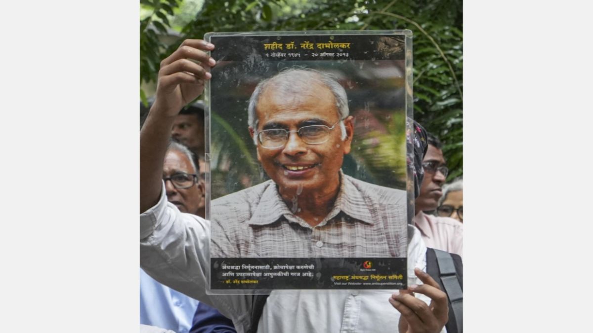 Maharashtra Andhashraddha Nirmulan Samiti member shows a portrait of Narendra Dabholkar during a ‘Nirbhay’ rally on his 10th death anniversary, in Mumbai on 19 August, 2023. He was fatally shot while on his morning walk near the VR Shinde bridge in Pune on 20 August 2013. File image/PTI Maharashtra Andhashraddha Nirmulan Samiti member shows a portrait of Narendra Dabholkar during a ‘Nirbhay’ rally on his 10th death anniversary, in Mumbai on 19 August, 2023. He was fatally shot while on his morning walk near the VR Shinde bridge in Pune on 20 August 2013. File image/PTI