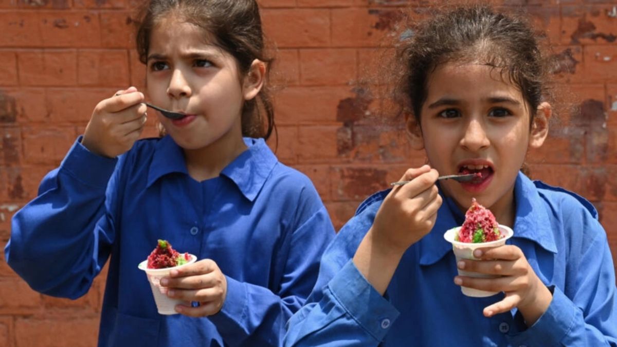 Students eat ice cream outside their school in Lahore, the capital city of Pakistan's Punjab province, where schools will close a week early because of extreme temperatures. AFP Students eat ice cream outside their school in Lahore, the capital city of Pakistan's Punjab province, where schools will close a week early because of extreme temperatures. AFP