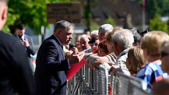 Slovakia's Prime Minister Robert Fico, centre, speaks with people before the cabinet's away-from-home session in the town of Handlova, Slovakia on 15 May, 2024. AP