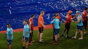 Sunrisers Hyderabad and Gujarat Titans players shake hands after their match in Hyderabad was washed out without a single ball bowled. AP