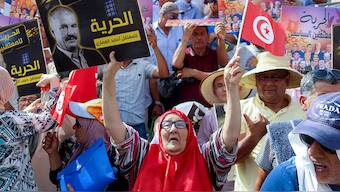 (File) Supporters of Tunisia's Salvation Front opposition coalition carry banners and flags during a protest against Tunisia's President Kais Saied on 25 July, 2023. Reuters