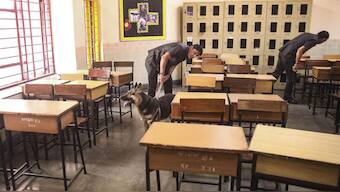 Security personnel check a classroom after bomb threats at schools in Delhi-NCR (Photo: PTI)