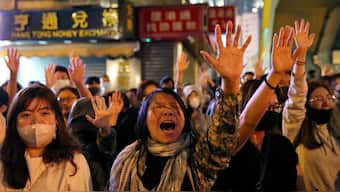 Protesters sing Glory to Hong Kong outside of Polytechnic University (PolyU) while police keep it under siege in Hong Kong, China, November 25, 2019. Reuters file