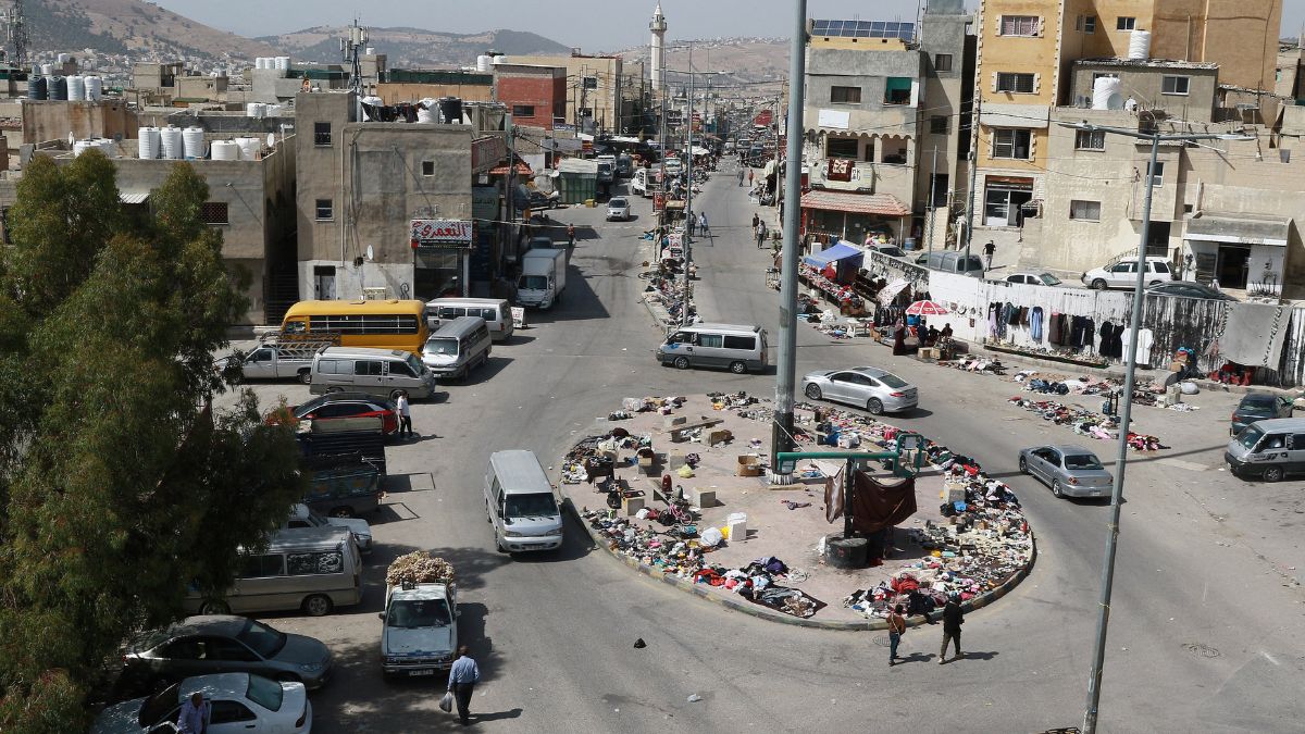 People display items for sale on a roundabout in the Palestinian refugee camp of Baqa'a near Amman on May 22, 2024. Ireland, Norway and Spain said they would formally recognise the State of Palestine on May 28, drawing praises from Palestinian leaders as well as many countries in the Arab and Muslim world, and fury from Israel. (Photo by Khalil MAZRAAWI / AFP) People display items for sale on a roundabout in the Palestinian refugee camp of Baqa'a near Amman on May 22, 2024. Ireland, Norway and Spain said they would formally recognise the State of Palestine on May 28, drawing praises from Palestinian leaders as well as many countries in the Arab and Muslim world, and fury from Israel. (Photo by Khalil MAZRAAWI / AFP)