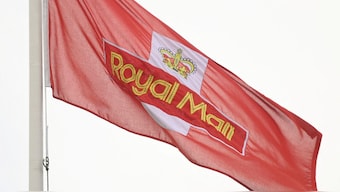 A Royal Mail flag flies near a sorting office as workers strike, in west London, Britain. Reuters