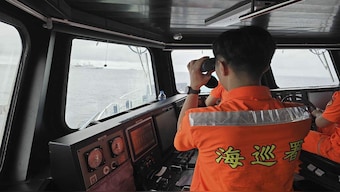 A Taiwan Coast Guard member monitor Chinese navy vessel operating near the Pengjia Islet north of Taiwan. Taiwan scrambled jets and put missile, naval and land units on alert Thursday over Chinese military exercises being conducted around the self-governing island democracy where a new president took office this week. AP