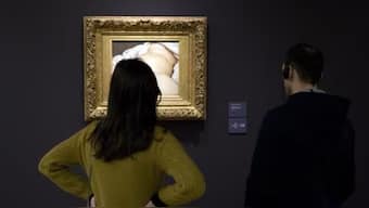 Two women defaced the iconic artwork of Gustave Courbet using spray paint. AP