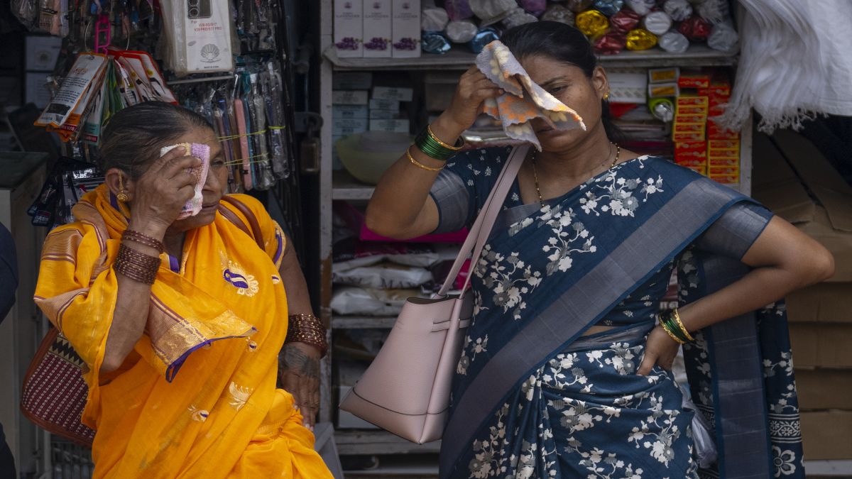 Women wipe the sweat from their faces as they wait for bus on a hot and humid summer day in Mumbai, India. A persistent heatwave has left people in India and in other parts of the world sweating and sweltering. AP Women wipe the sweat from their faces as they wait for bus on a hot and humid summer day in Mumbai, India. A persistent heatwave has left people in India and in other parts of the world sweating and sweltering. AP