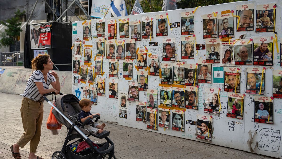 Passersby observe the photos of hostages held in the Gaza Strip that are plastered to the walls of a plaza known as Hostages Square in Tel Aviv, Israel, 17 May, 2024. AP File Passersby observe the photos of hostages held in the Gaza Strip that are plastered to the walls of a plaza known as Hostages Square in Tel Aviv, Israel, 17 May, 2024. AP File