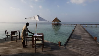 A waiter prepares the table at a restaurant at a resort on an island at Har Alif Atoll in the Maldives. The island nation has witnessed a dip in Indian tourists amid the ongoing New Delhi-Male spat. File image/Reuters