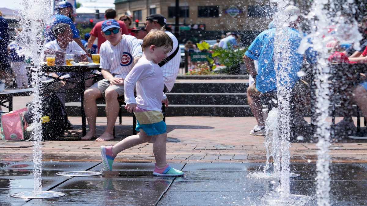 A kid cools off at Gallagher Way park fountain during hot weather in Chicago. AP A kid cools off at Gallagher Way park fountain during hot weather in Chicago. AP