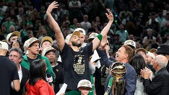 Boston Celtics forward Jayson Tatum, center, celebrates with to Celtics co-owner Stephen Pagliuca, center right, near the Larry O'Brien Championship Trophy after the Celtics won the NBA championship with a Game 5 victory over the Dallas Mavericks. AP