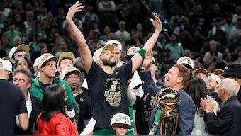 Boston Celtics forward Jayson Tatum, center, celebrates with to Celtics co-owner Stephen Pagliuca, center right, near the Larry O'Brien Championship Trophy after the Celtics won the NBA championship with a Game 5 victory over the Dallas Mavericks. AP