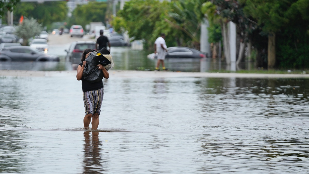 A woman walks through a flooded street in Northeast Miami-Dade County, Florida. AP A woman walks through a flooded street in Northeast Miami-Dade County, Florida. AP