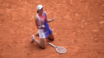 Iga Swiatek celebrates after winning the 2024 French Open. This was her fifth Grand Slam title and fourth major win at Roland Garros. AP