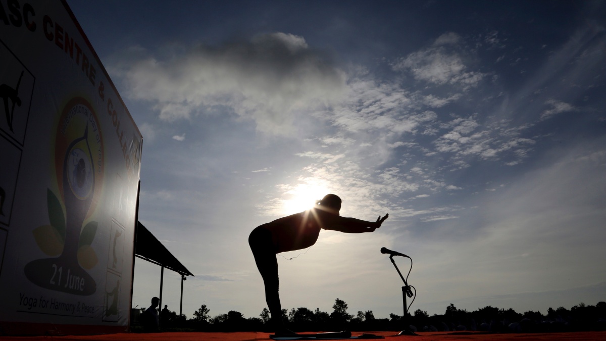 An Indian yoga instructor leads a large group of army soldiers at a yoga session to mark International Yoga Day on 21 June in Bengaluru. AP An Indian yoga instructor leads a large group of army soldiers at a yoga session to mark International Yoga Day on 21 June in Bengaluru. AP