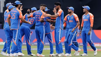 Hardik Pandya celebrates the dismissal of Aaron Jones with his teammates. AP 