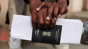 A skilled worker waits with his passport for his interview and skill test at a Haryana state government recruitment drive to send workers to Israel, at Maharshi Dayanand University in Rohtak on 17 January, 2024. Reuters