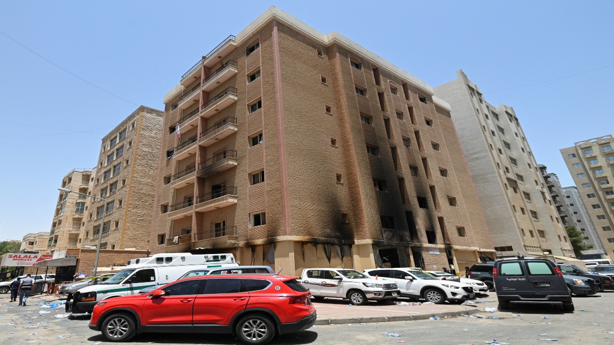 Vehicles are parked next to a building damaged following a deadly fire, in Mangaf, southern Kuwait, on Wednesday. Reuters Vehicles are parked next to a building damaged following a deadly fire, in Mangaf, southern Kuwait, on Wednesday. Reuters