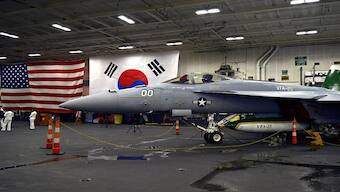 An F-18 fighter aircraft sits in the hanger of the Theodore Roosevelt (CVN 71), a nuclear-powered aircraft carrier, anchored in Busan Naval Base in Busan, South Korea. AP
