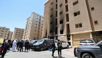 Kuwaiti police officers are seen in front of a burnt building following a deadly fire, in Mangaf, southern Kuwait, June 12, 2024. Source: REUTERS.