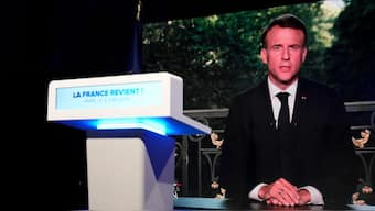 French President Emmanuel Macron appears on television screen at the French far-right National Rally party election night headquarters, 9 June, 2024 in Paris. Macron dissolved the National Assembly and called new legislative election after defeat in EU vote. AP