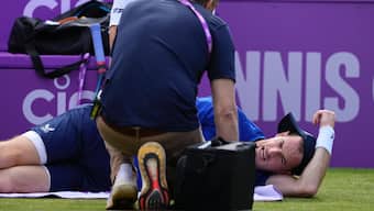 Andy Murray receives medical treatment before he retired due to injury from his match against Jordan Thompson during their men's singles match at Queen's. AP