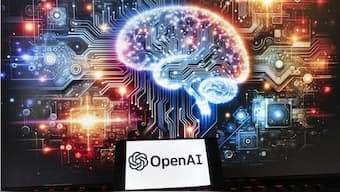 The OpenAI logo is seen displayed on a cell phone with an image on a computer monitor generated by ChatGPT's Dall-E text-to-image model, 8 December, 2023, in Boston. File Image/AP
