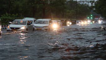 Vehicles crawl through a waterlogged road amid rains, in New Delhi, Friday morning, 28 June 2024. PTI