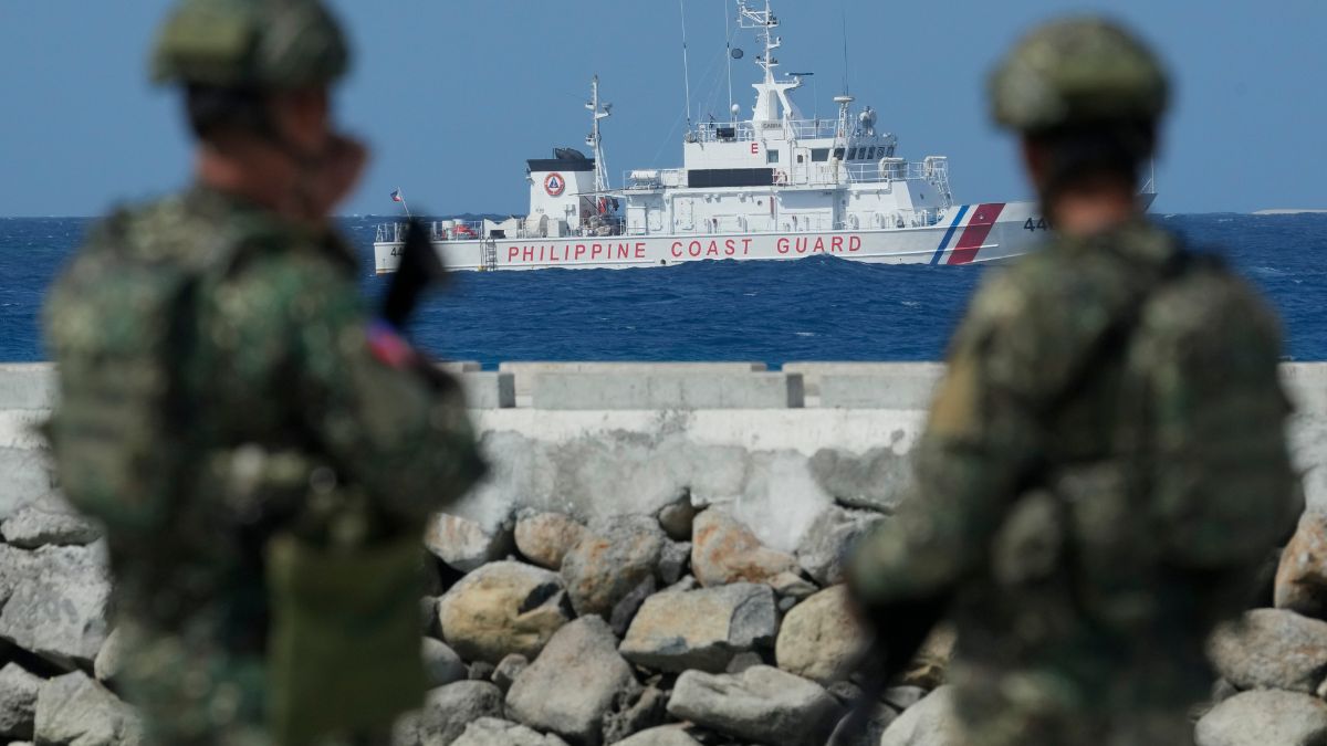 FILE - Philippine troops watch a Philippine coast guard ship as they secure an area at the Philippine-occupied Thitu island, locally called Pag-asa island, on Dec. 1, 2023, at the disputed South China Sea. - AP FILE - Philippine troops watch a Philippine coast guard ship as they secure an area at the Philippine-occupied Thitu island, locally called Pag-asa island, on Dec. 1, 2023, at the disputed South China Sea. - AP