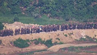 In this undated photo provided on Tuesday, June 18, 2024, by South Korea Defense Ministry, North Korean soldiers work at an undisclosed location near the border area, as seen from a South Korean guard area.- AP