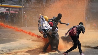 Protesters scatter as Kenya police spray water canon at them during a protest over proposed tax hikes in a finance bill in downtown Nairobi, Kenya Tuesday, June. 25, 2024. File image/AP