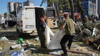 Municipal workers carry a dead body killed after an apartment building was hit by Russian air bomb killing at least three and injuring 23, in Kharkiv, Ukraine on 22 June, 2024. AP