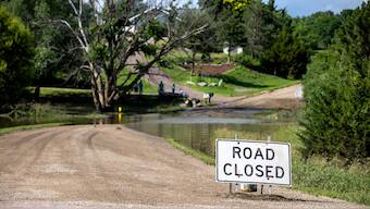 A road is closed off due to flooding caused by heavy rainfall, 22 June, 2024, in Lincoln County, South Dakota, USA. AP