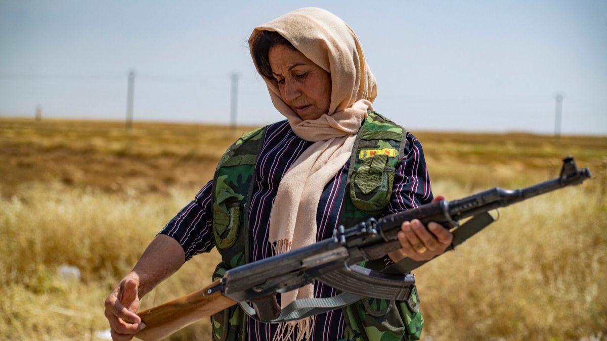 A volunteer in the Kurdish Community Protection Forces checks her rifle as she guards wheat fields from fire or looting around the town of Tarbesbeyeh, also known as al-Qahtaniyah in Arabic, in northeastern Syria's Hasakeh Governorate near the Turkish border. AFP A volunteer in the Kurdish Community Protection Forces checks her rifle as she guards wheat fields from fire or looting around the town of Tarbesbeyeh, also known as al-Qahtaniyah in Arabic, in northeastern Syria's Hasakeh Governorate near the Turkish border. AFP