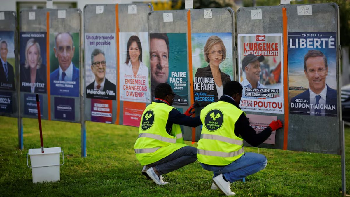 France Affichage Plus workers paste official campaign posters of French Presidential election candidates on electoral panels in Saint-Herblain near Nantes, France, March 28, 2022. REUTERS France Affichage Plus workers paste official campaign posters of French Presidential election candidates on electoral panels in Saint-Herblain near Nantes, France, March 28, 2022. REUTERS