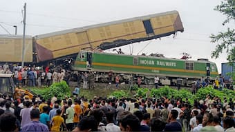 Onlookers watch as rescuers work after a cargo train rammed into Kanchanjunga Express, a passenger train, near New Jalpaiguri station, West Bengal on 17 June 2024. AP